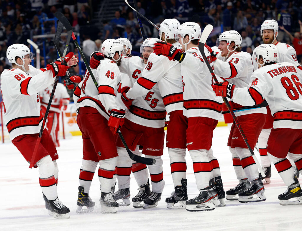 Carolina Hurricanes defenseman Jani Hakanpaa (58) is congratulated by  teammates after scoring a goal during the third period of an NHL hockey  game against the Dallas Stars, Monday, April 26, 2021, in